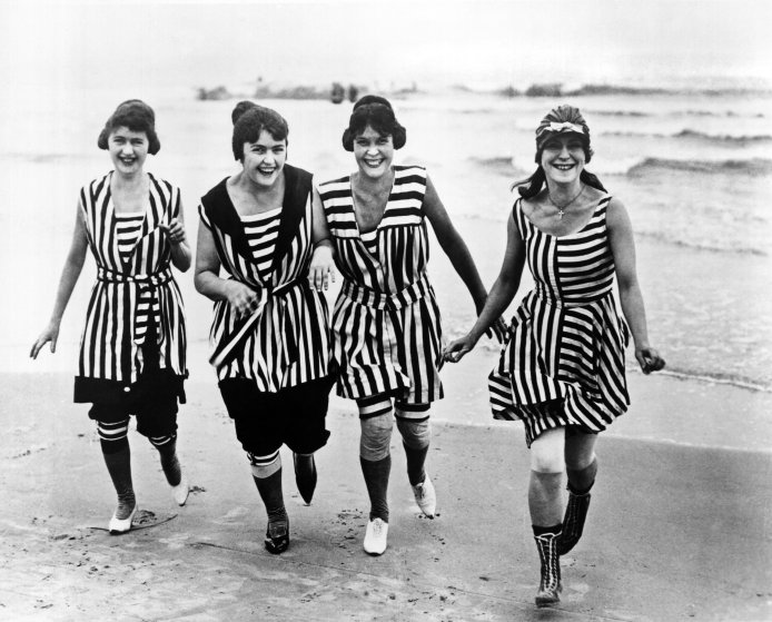 Four young women in matching beach wear run out of the surf, Los Angeles, California, circa 1910. (Photo by Underwood Archives/Getty Images)