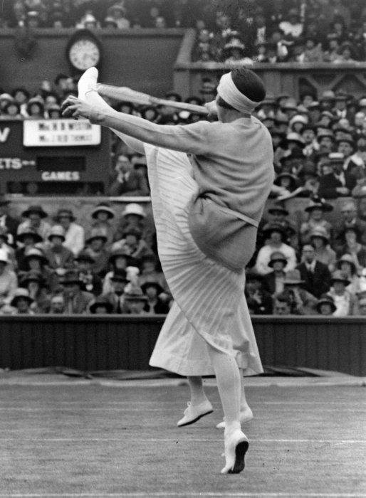 1924 French champion Suzanne Lenglen (1899 – 1938) playing at Wimbledon