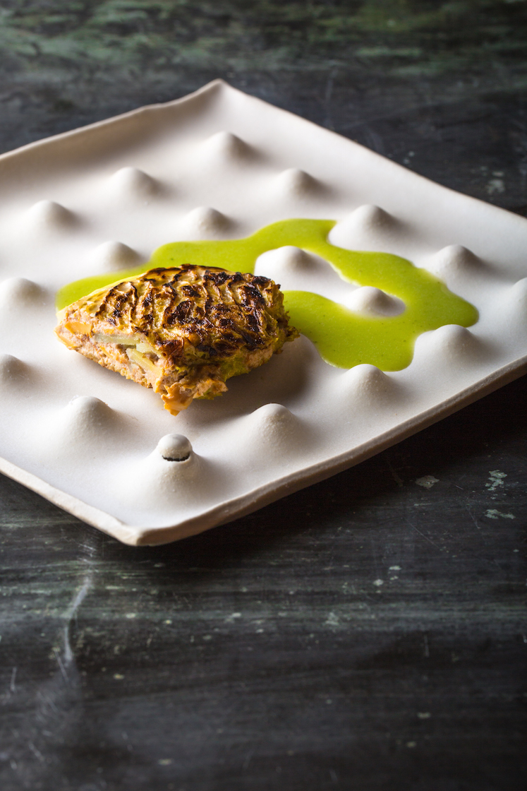 Cabbage, Potato, Chanterelles, Walnut, Lovage from chef Daniel Patterson (Coi) served on a slab-drop plate by Luke Shalan.