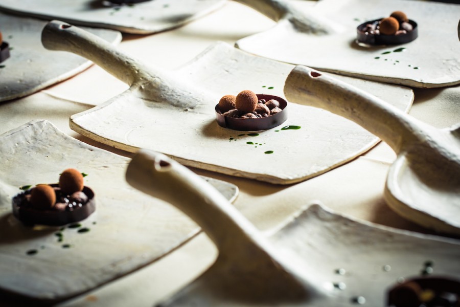 Pastry chef Stephanie Prida (Manresa) setting Garden Herb Sorbet and Bitter Cacao on shovel plates by Joe Pintz.