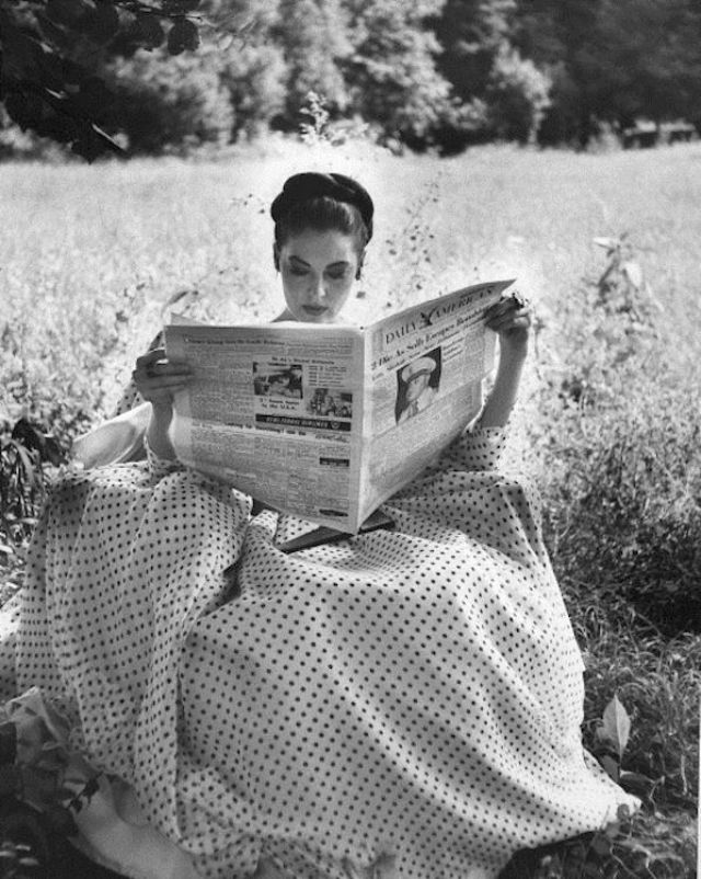 Ava Gardner reading in a garden