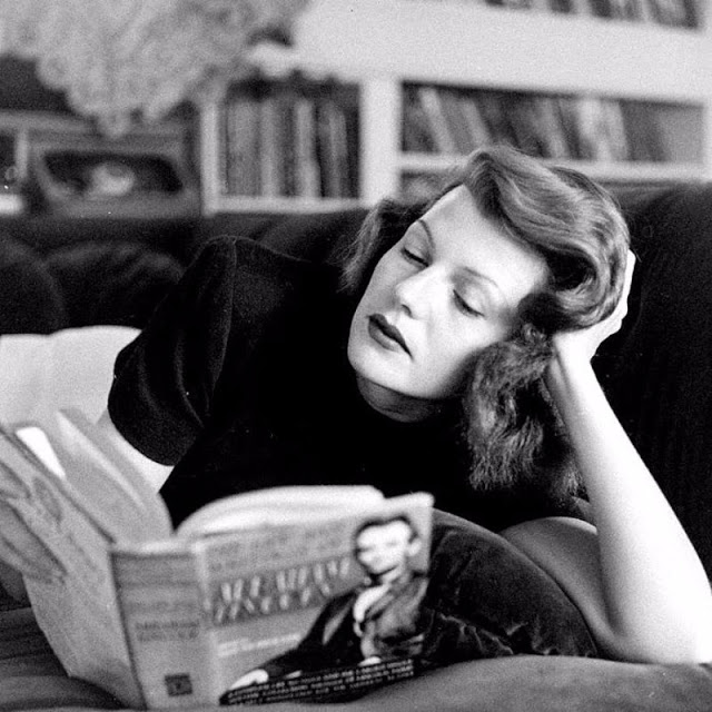 Rita Hayworth reading a book